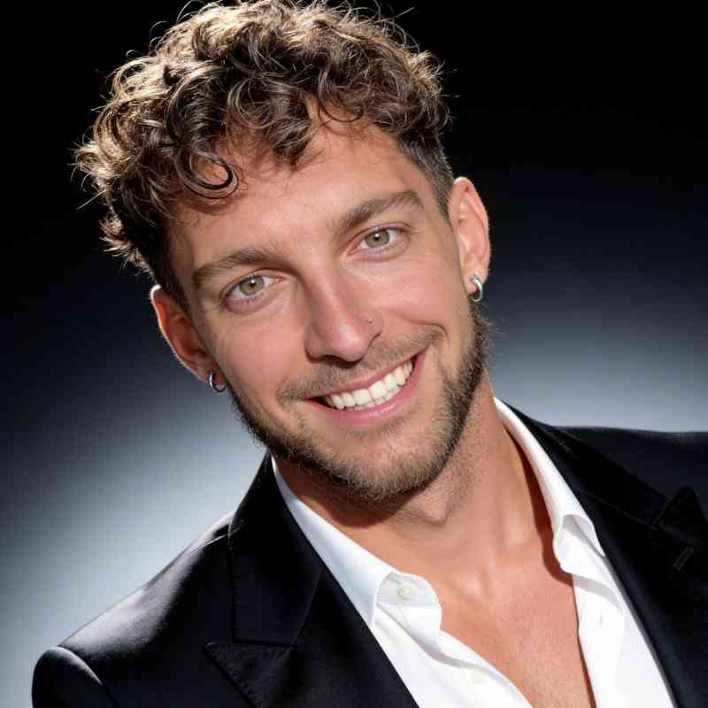 Male Escort Alvaro from haut-nah.org portrait shot with black suit, laughing, headshot